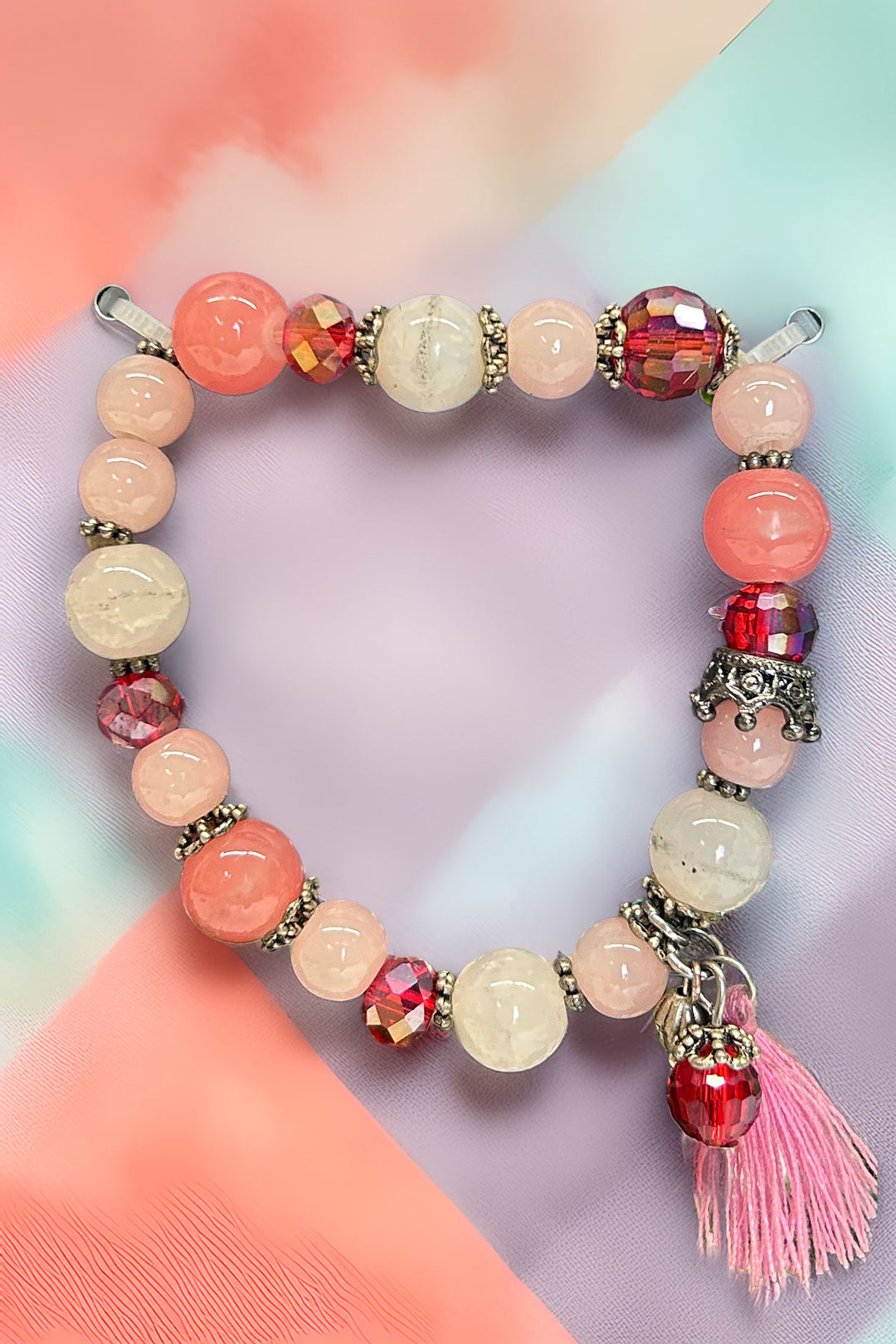 Colorful beaded bracelet with pink tassel charm