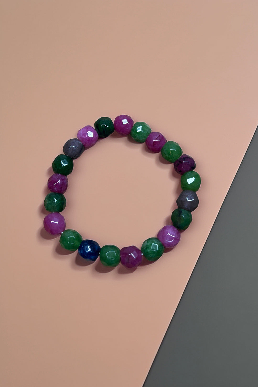 Multicolor beaded bracelet with assorted colored beads on a neutral background