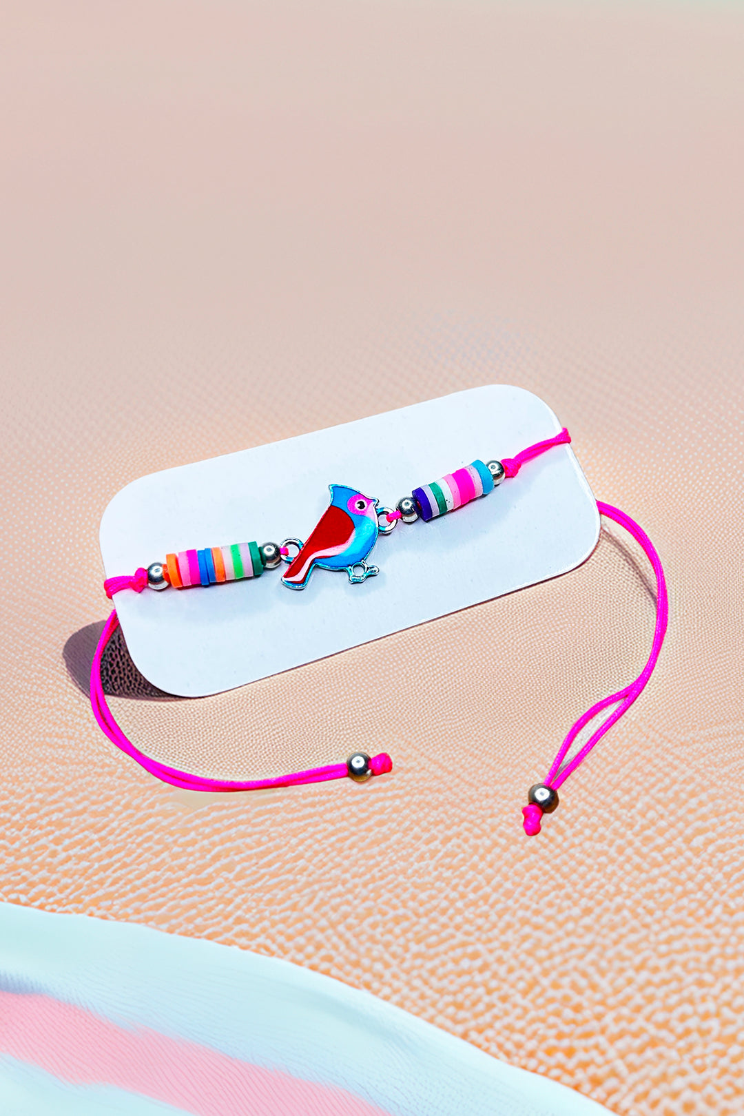 Toucan charm with colorful beads bracelet on display
