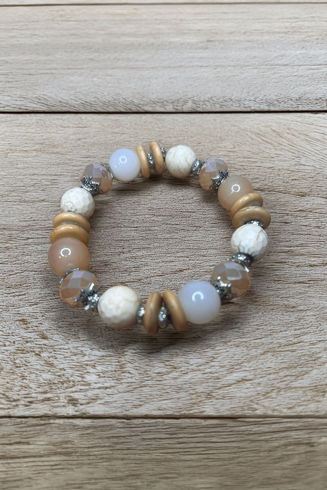 Elegant beaded bracelet on wooden surface