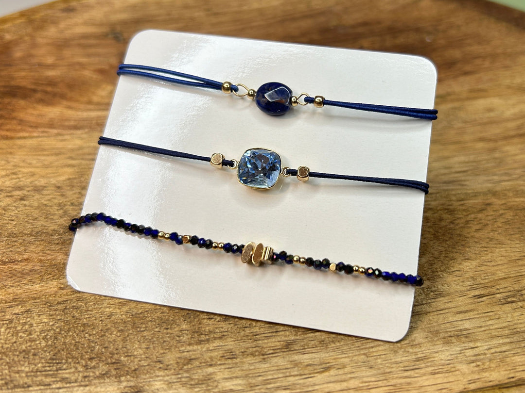 Blue and gold bracelet set displayed on a wooden surface.