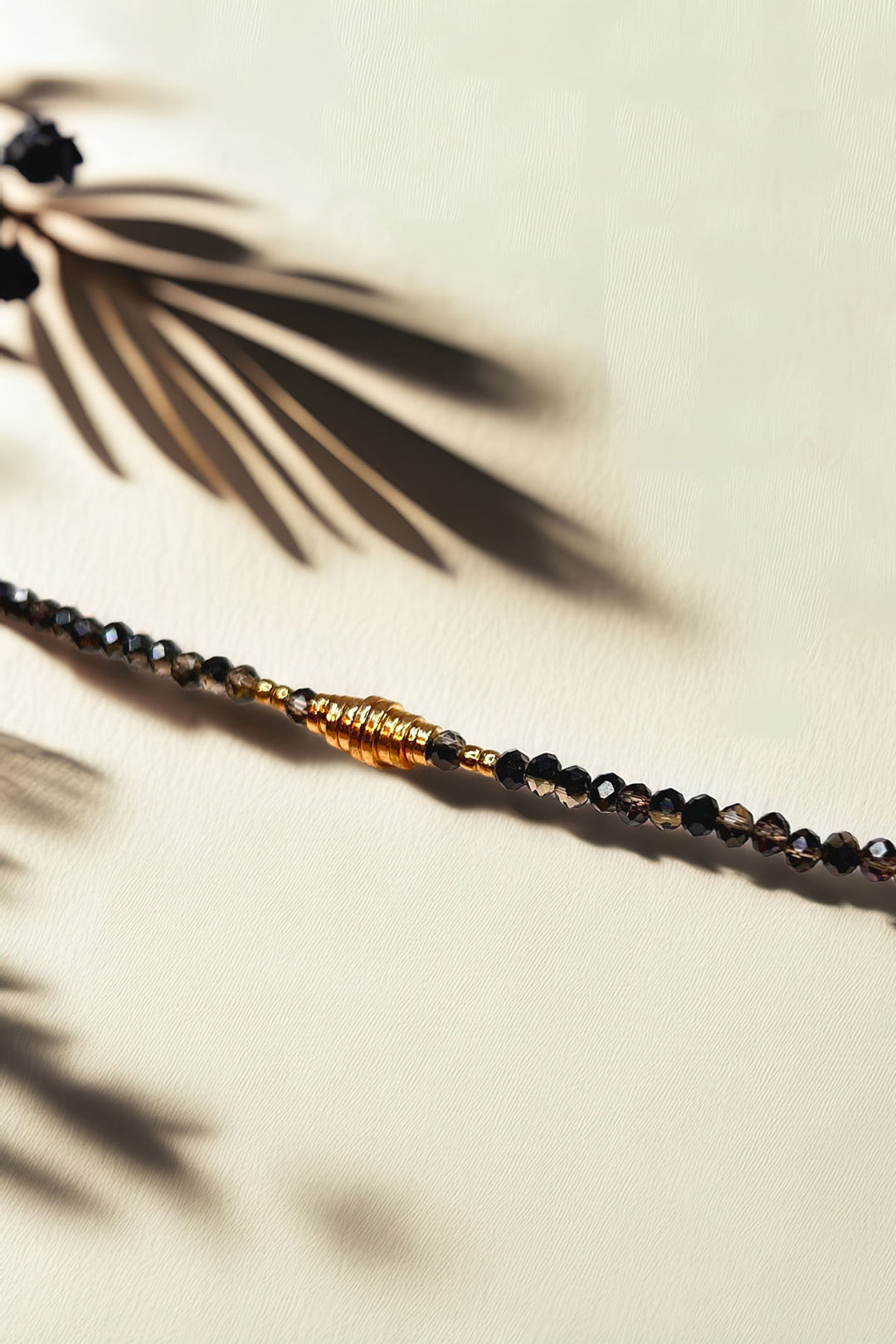 Close-up of the beaded bracelet highlighting gold accents and intricate bead design