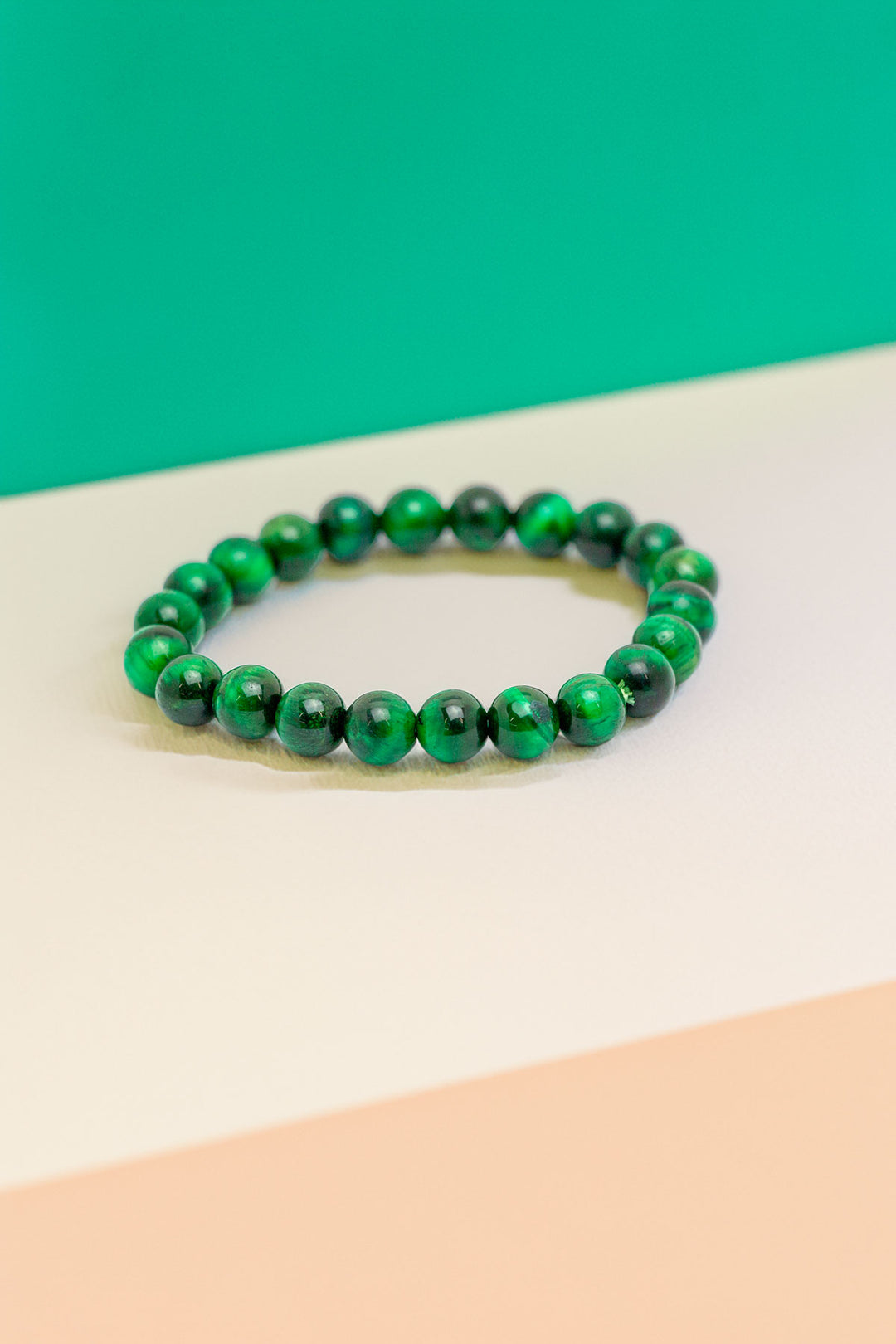 Handcrafted green beaded bracelet on a colorful backdrop
