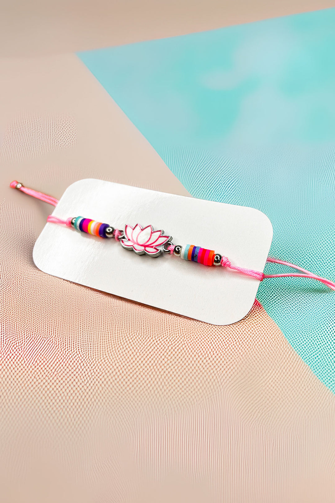 Front view of the vibrant lotus charm bracelet on a display card