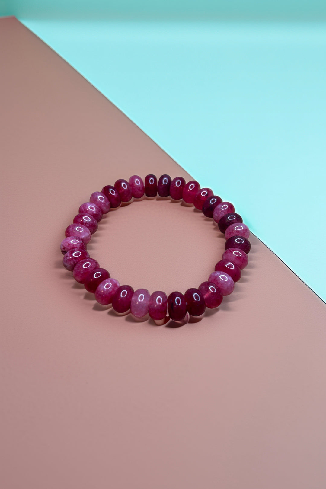 Ruby red bracelet on a teal and brown background