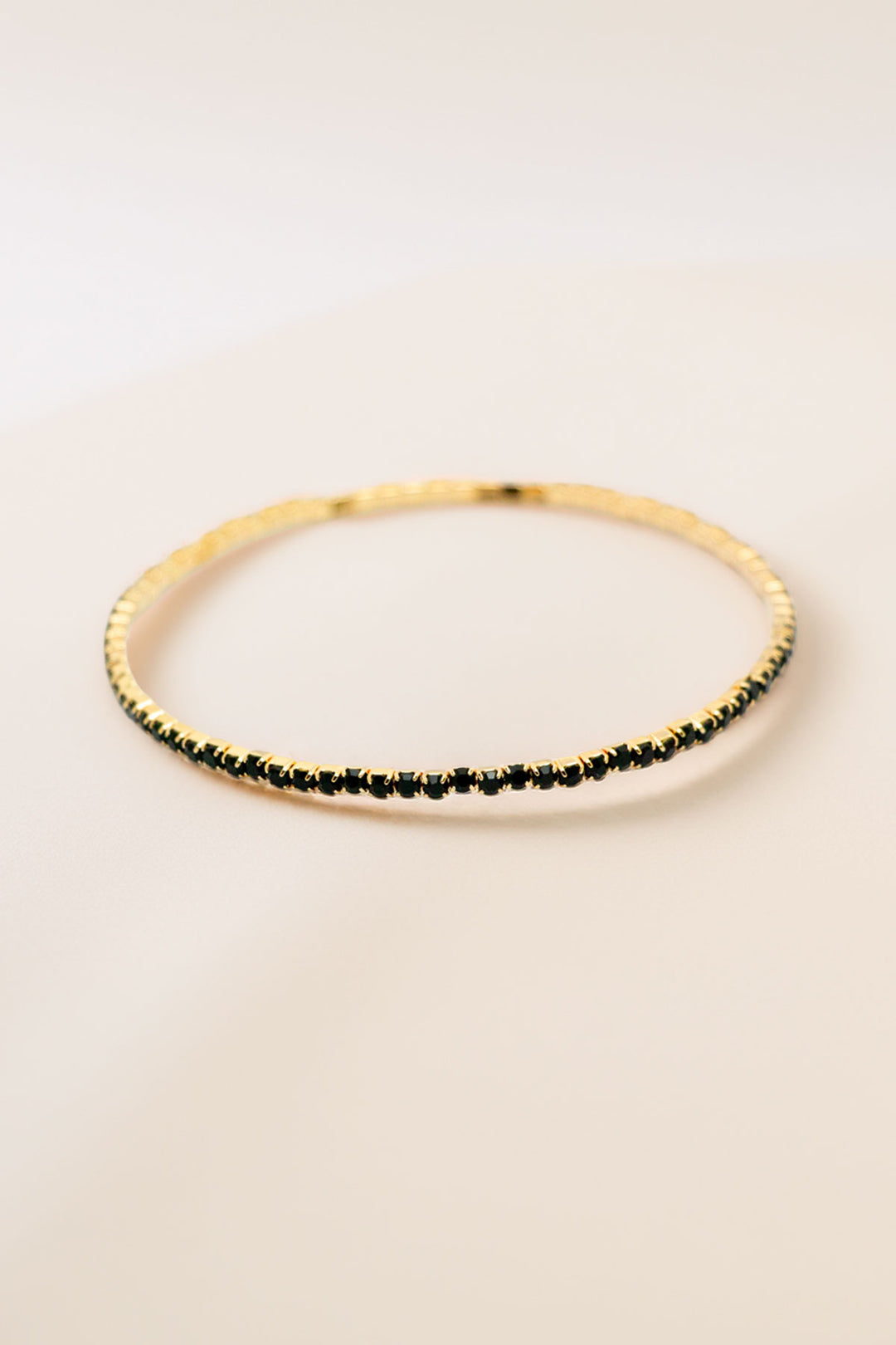 Single gold-tone rhinestone bracelet flat view