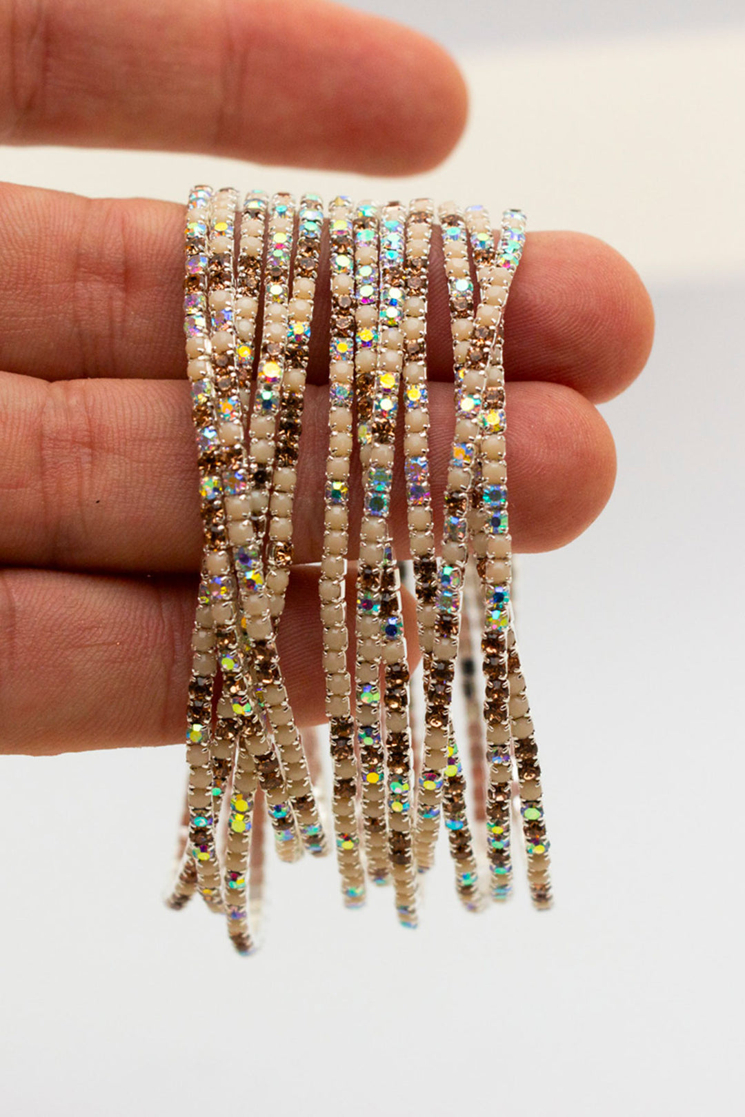 Close-up of rhinestone bangles held in hand