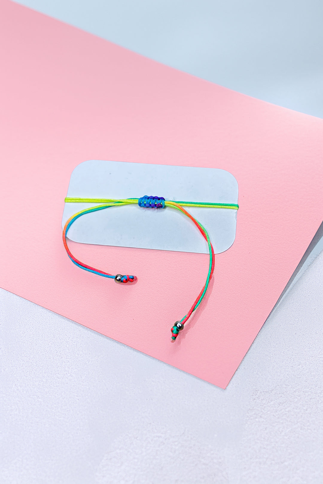 Rear view of the rainbow friendship bracelet with adjustable ties