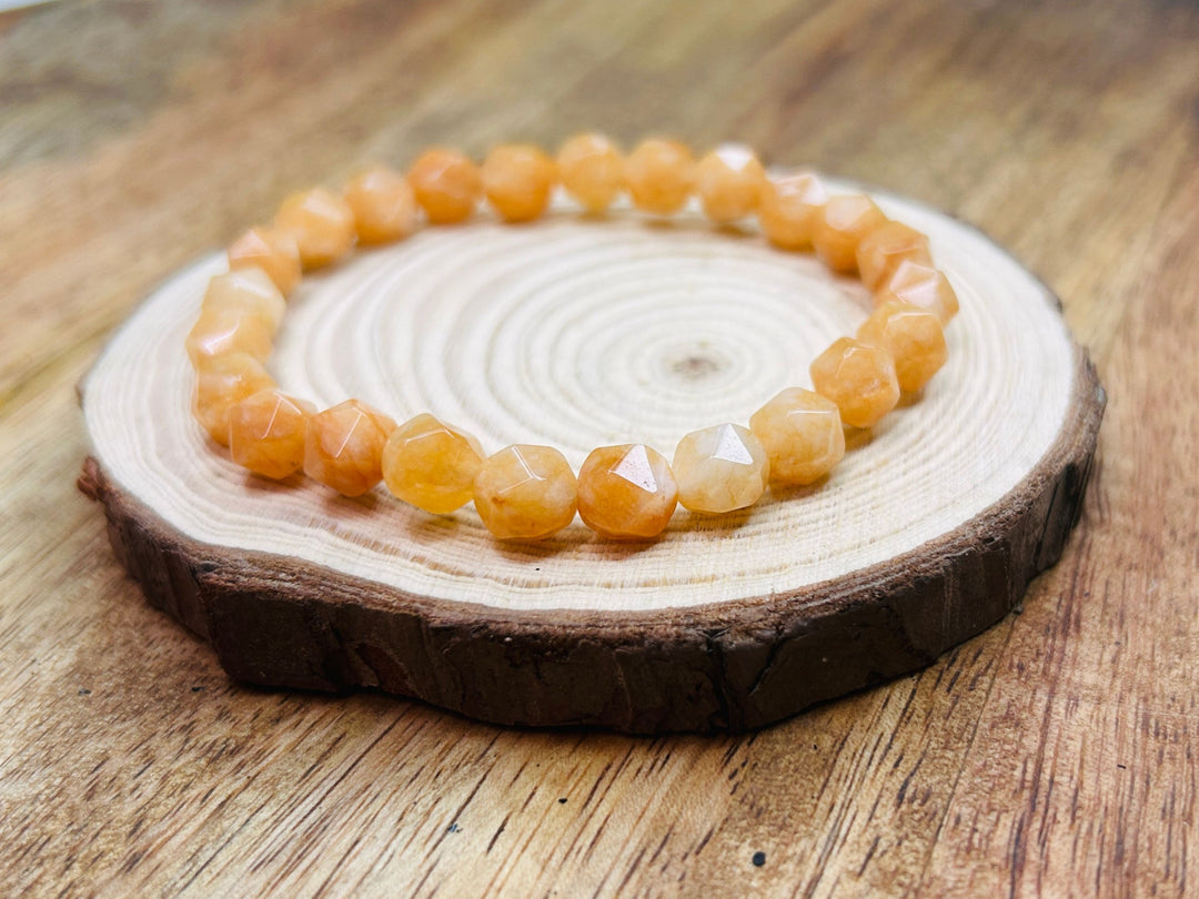 Orange beaded bracelet on wooden display