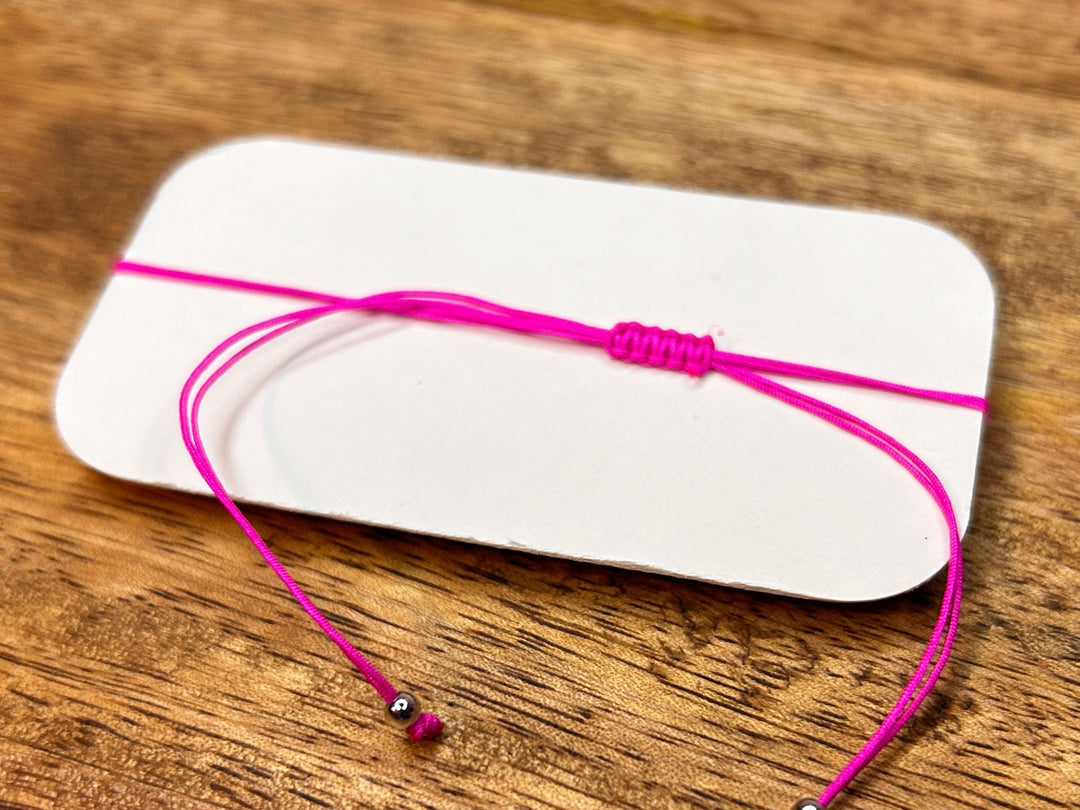 Back view showing adjustable pink string of the beaded bracelet