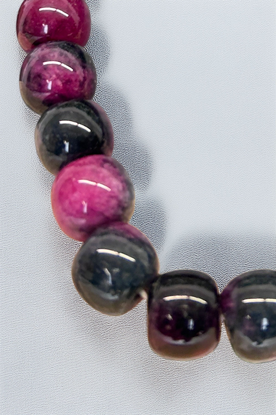 Close-up of pink and black beads on the bracelet by Mimi's Gift and Jewelry