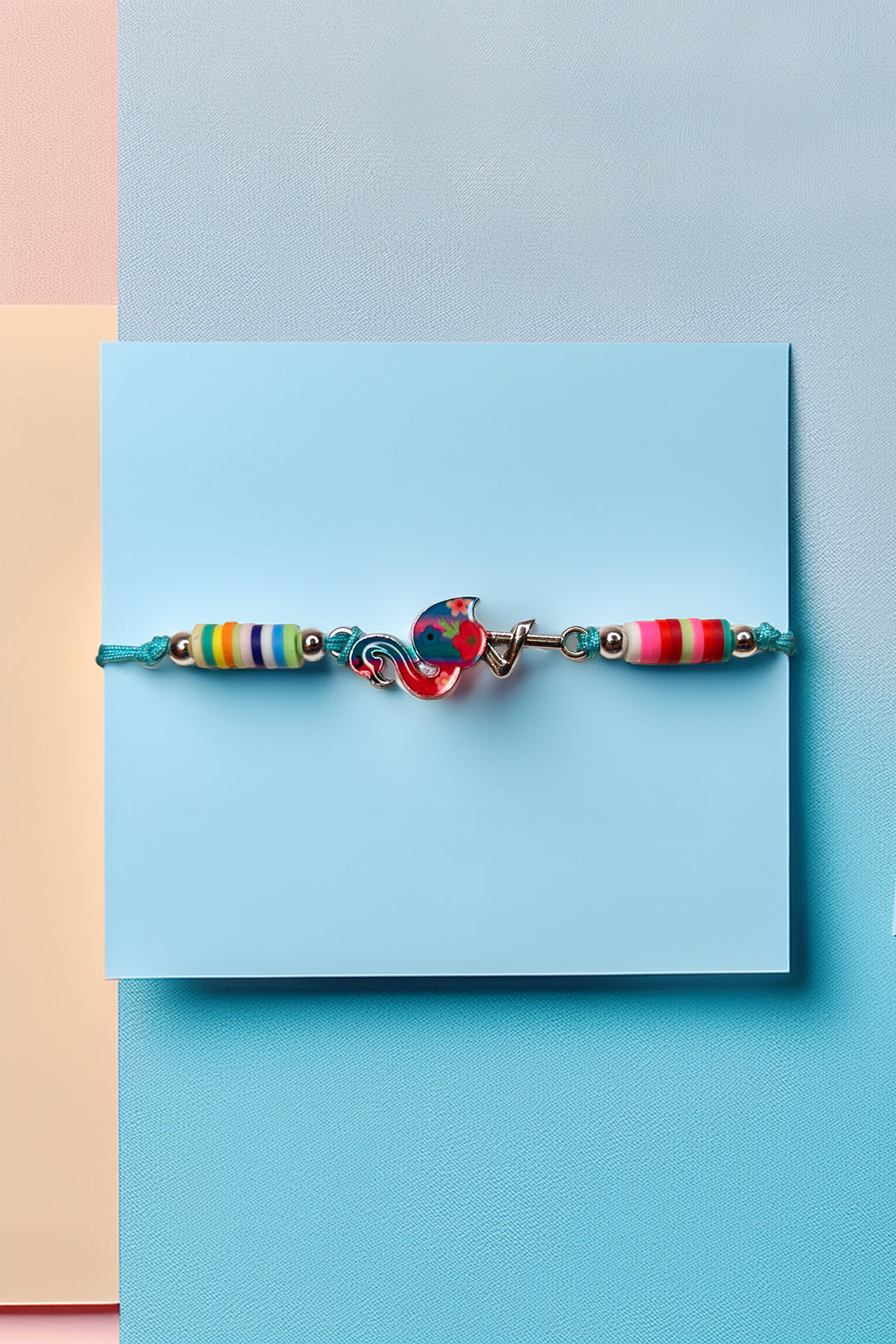 Close-up of rainbow bead friendship bracelet on blue background