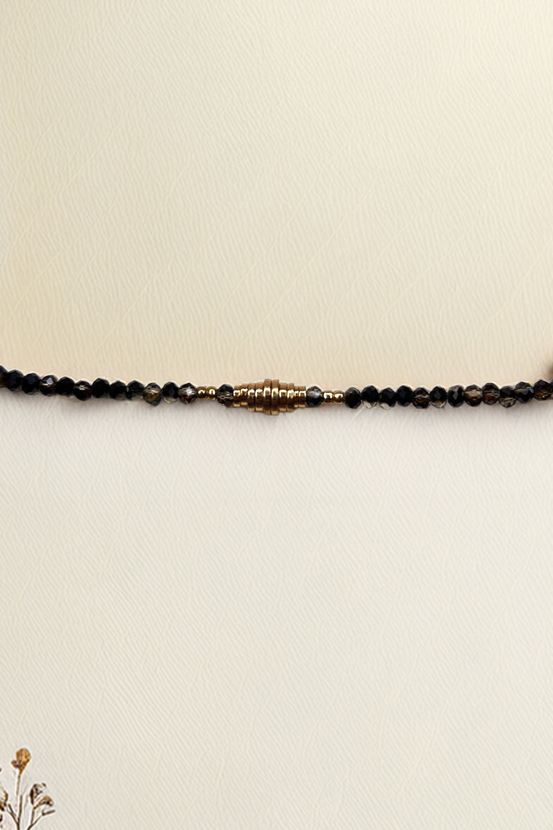 Full view of beaded bracelet with stylish gold centerpiece