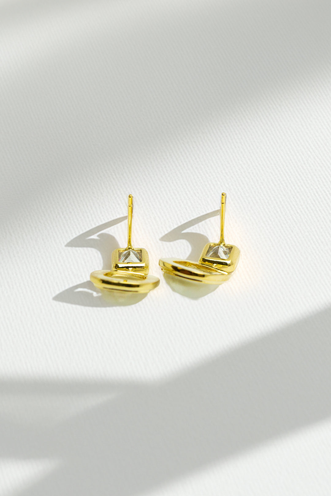 Top view of gold-tone dangle earrings
