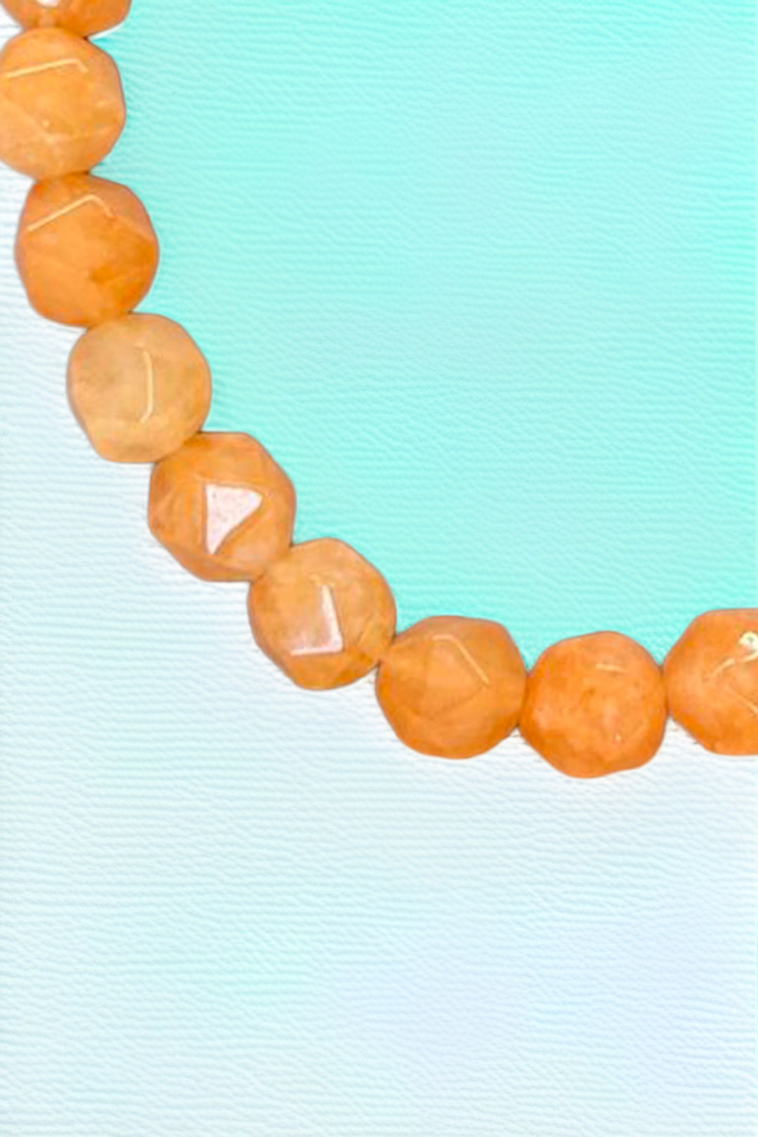 Close-up of orange beads on beaded bracelet