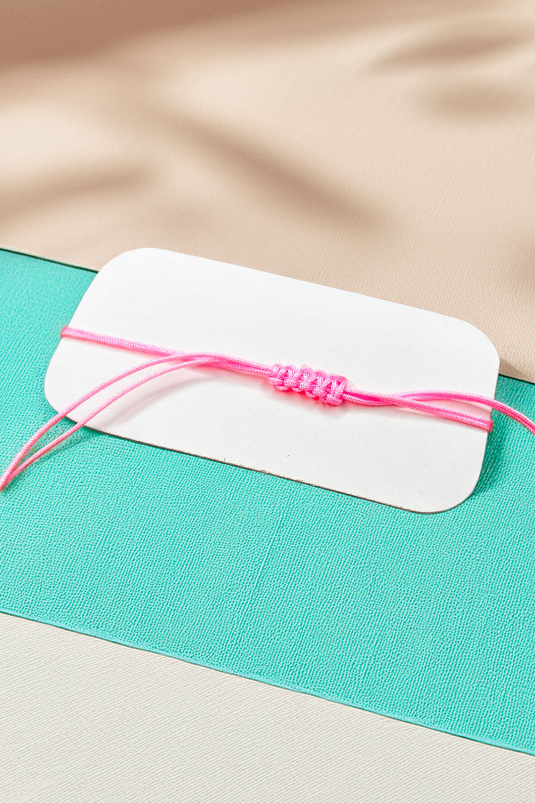 Back view of the adjustable pink cord bracelet