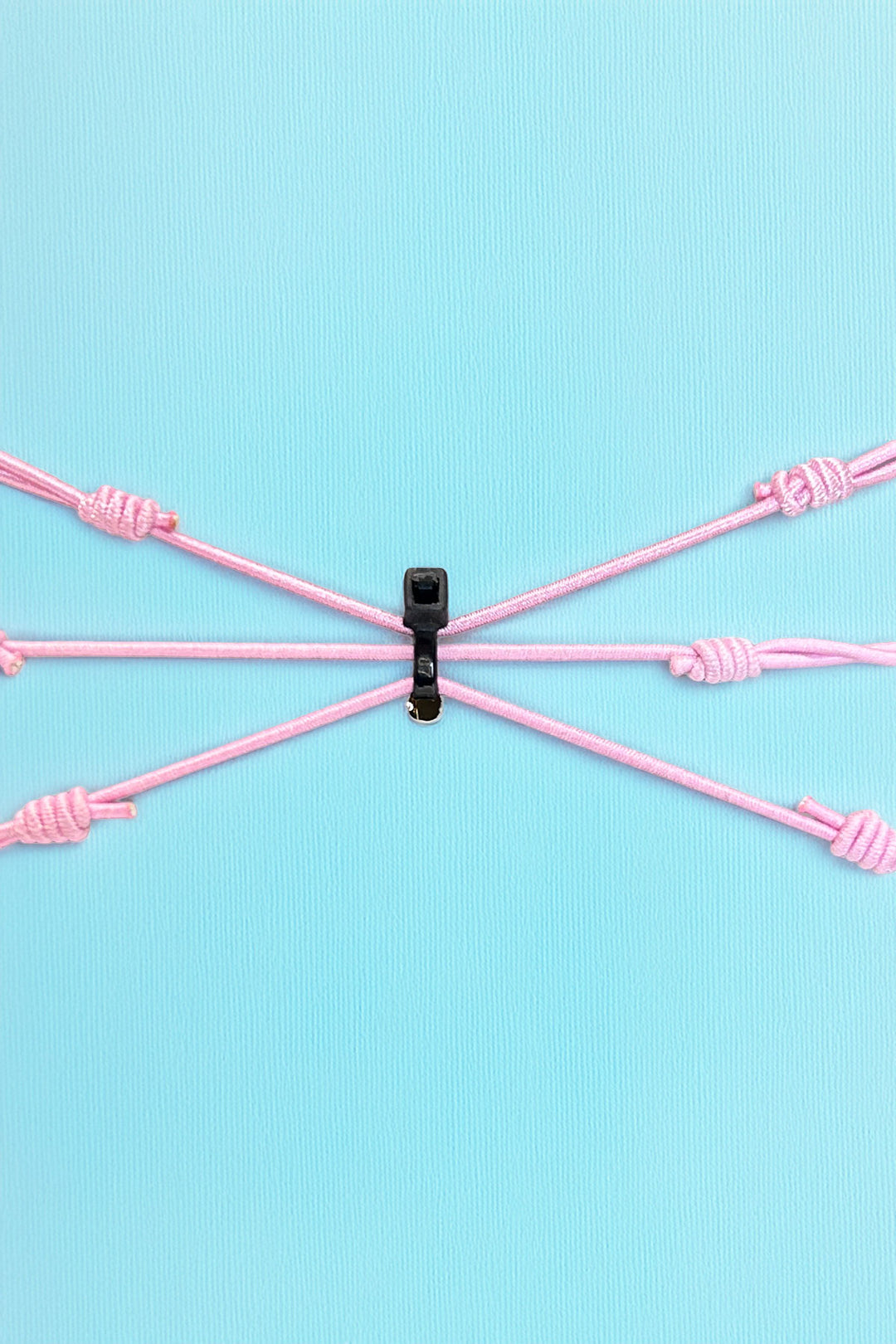 Back view of adjustable pink bracelet set with knot details
