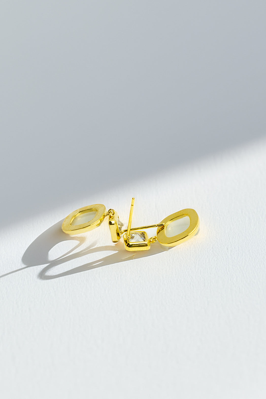 Side view of gold-tone dangle earrings