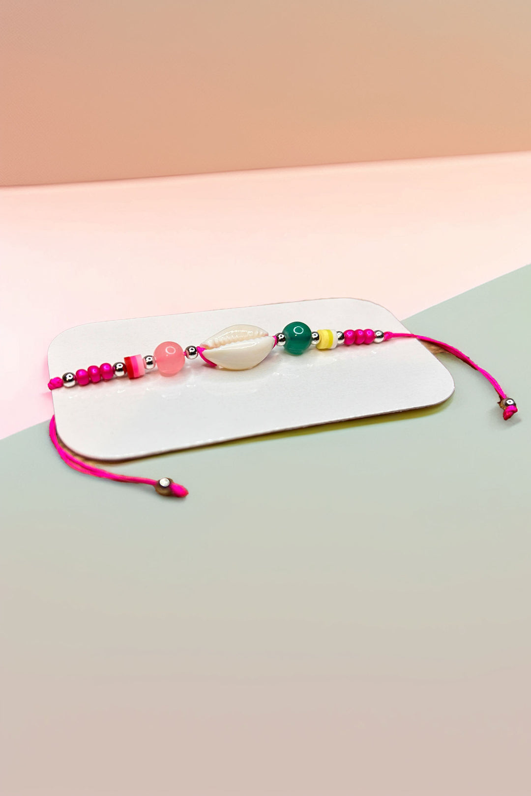 Side angle of multicolored beaded bracelet with shell