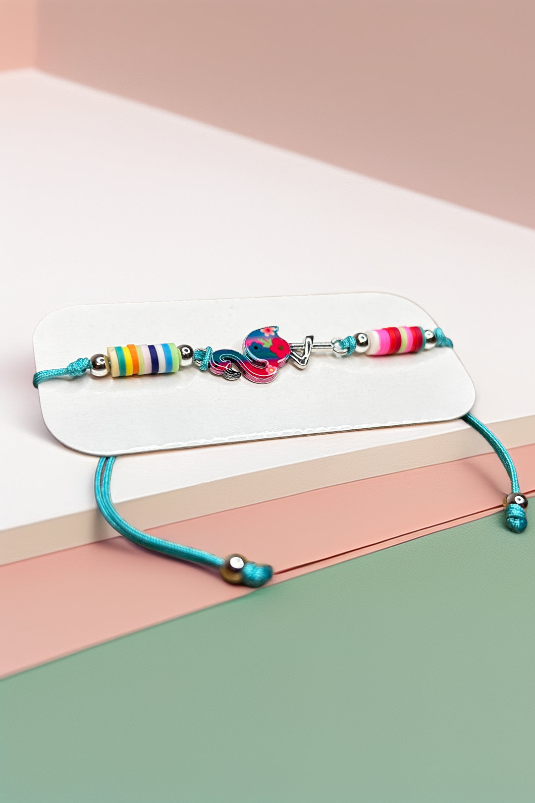 Side angle of colorful bracelet on pastel surface