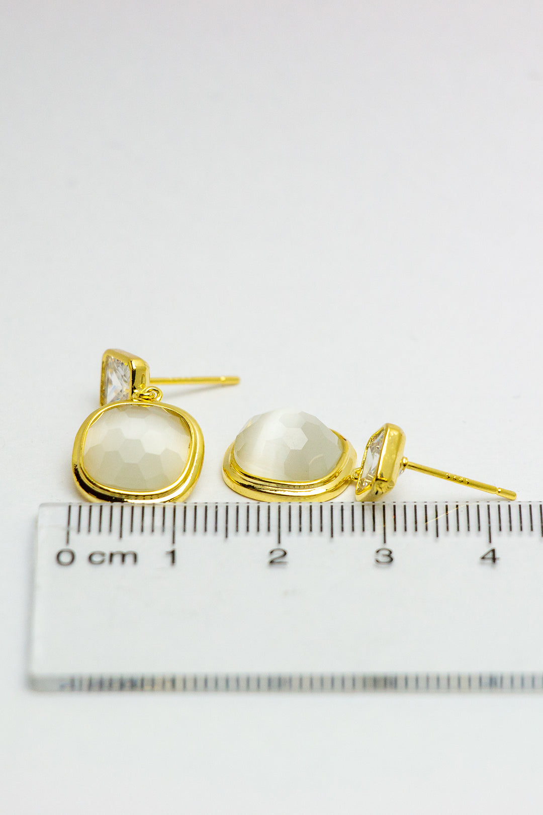 Detailed side angle of dangle earrings