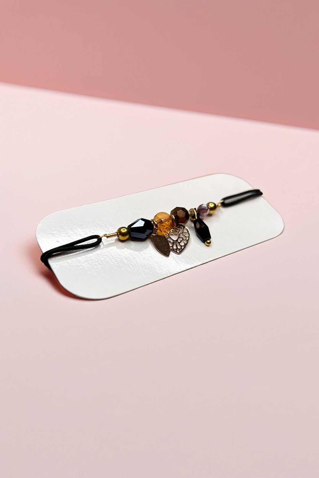 Side angle of bracelet with pink background