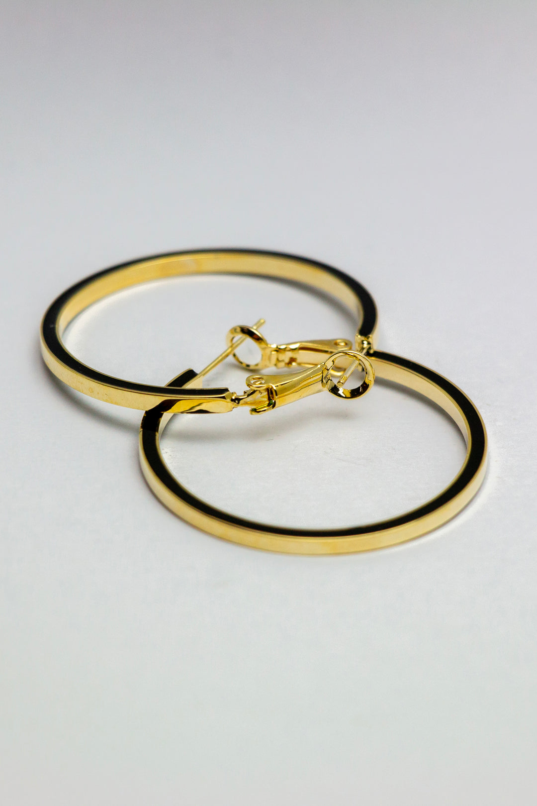 Gold hoop earrings with secured clasp