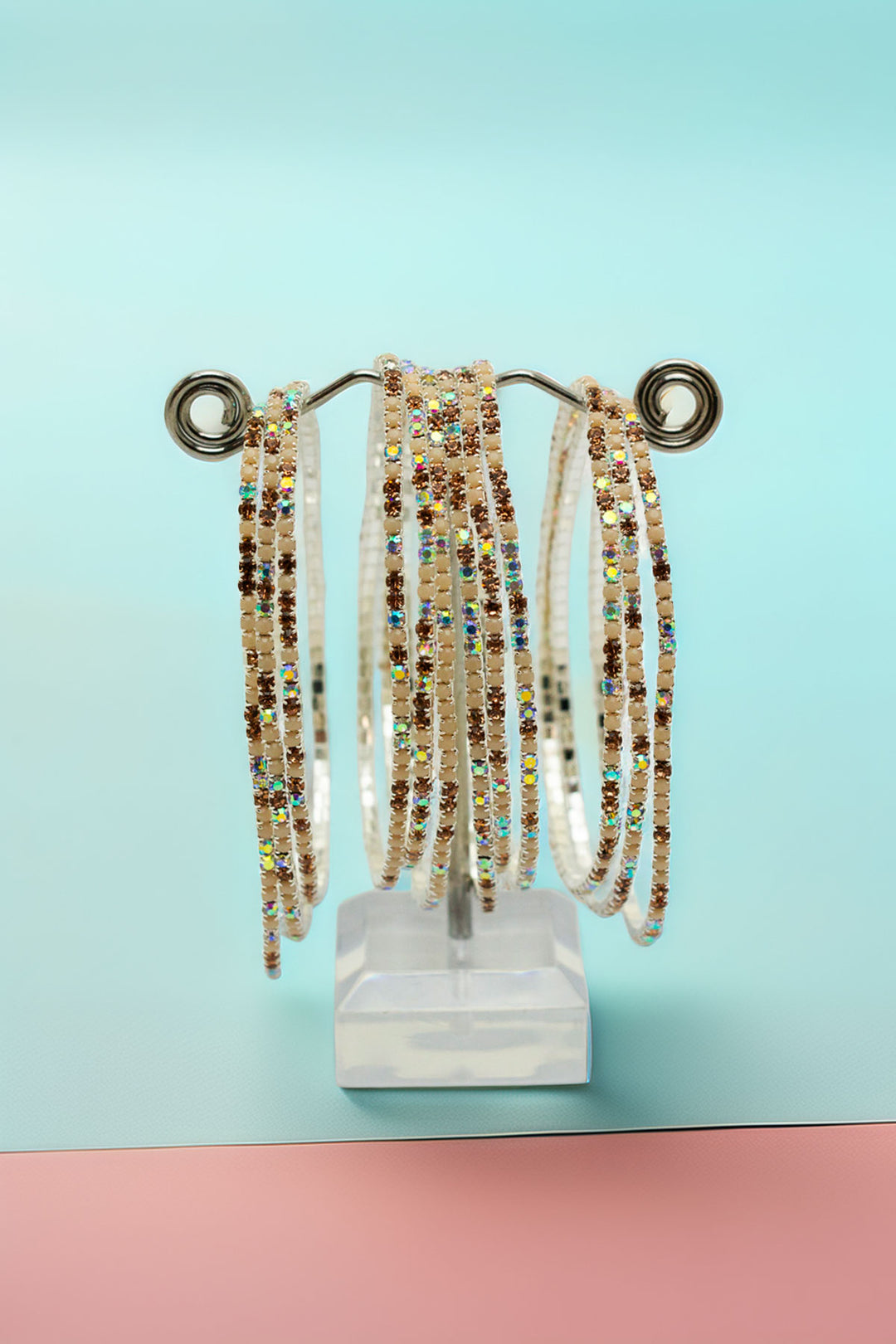 Rhinestone bangles on a pastel background