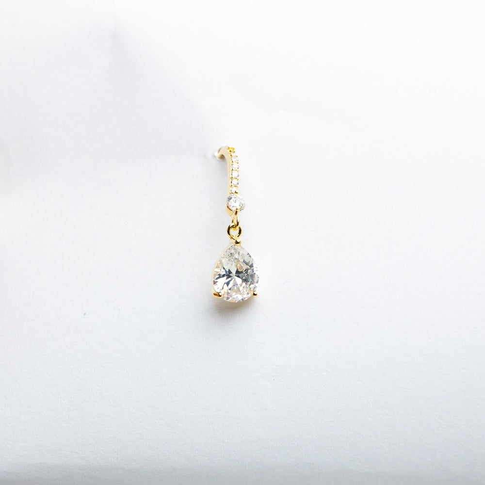 Gold dangle earring with crystal close-up