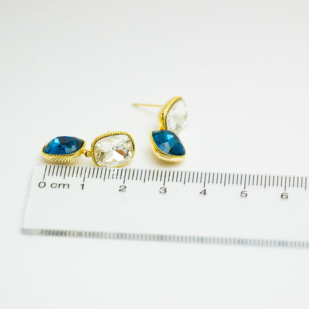 Crystal earrings beside a ruler for size comparison