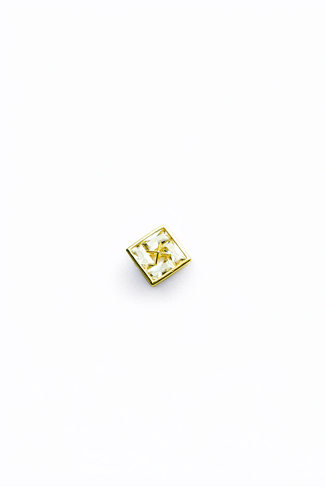 Single gold-tone stud earring close-up