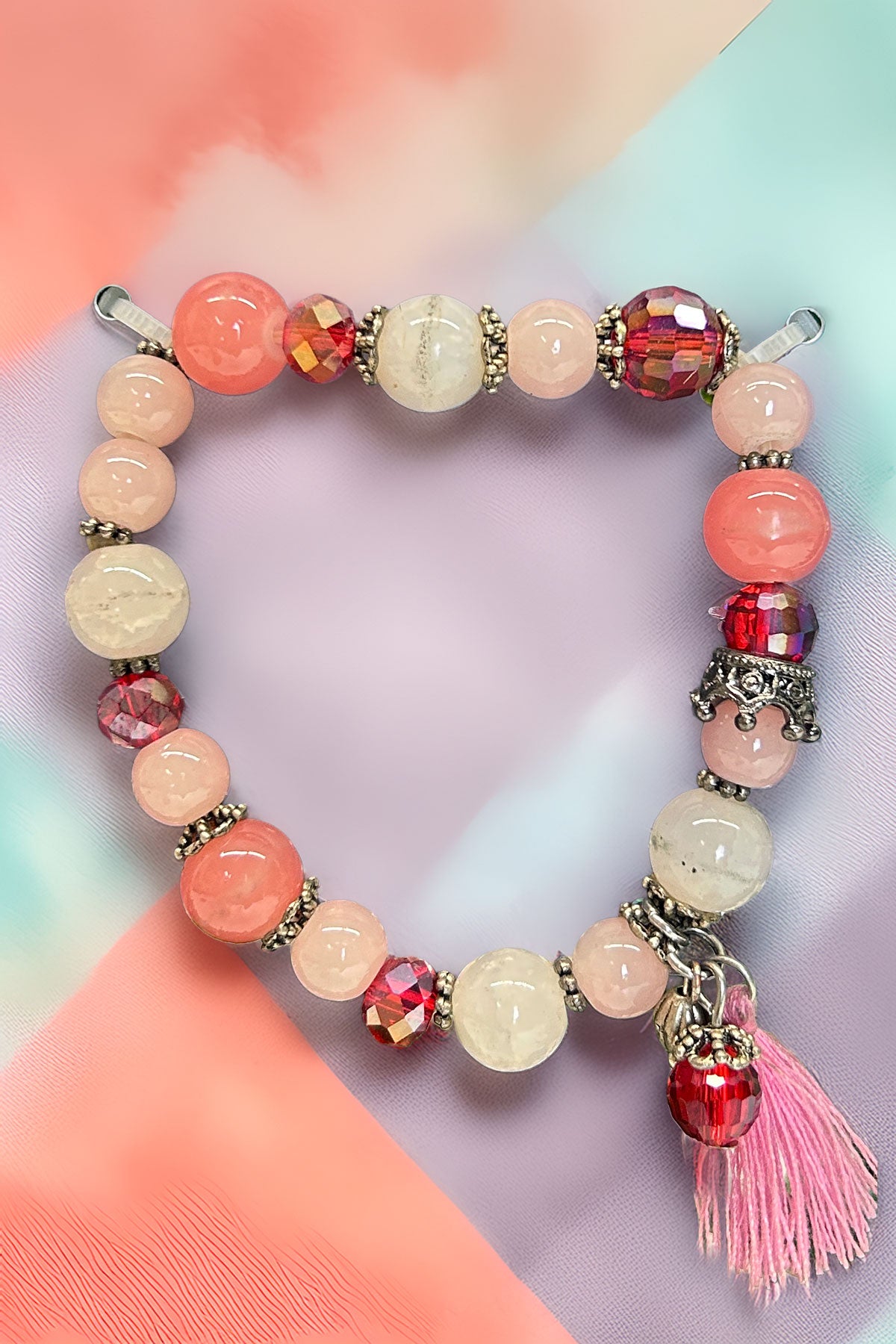 Colorful beaded bracelet with pink tassel charm