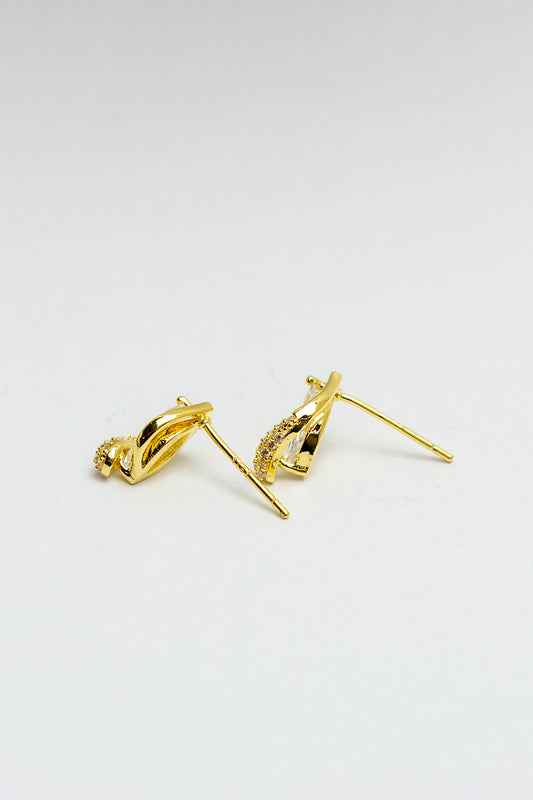 Gold stud earrings with crystal accents, side view