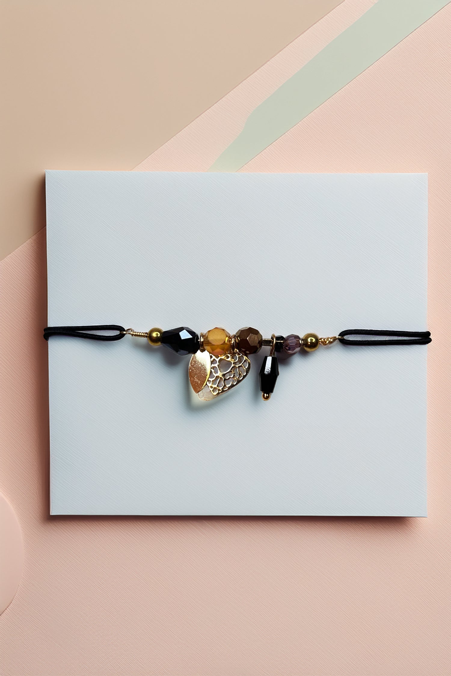 Main view of beaded charm bracelet with gold-tone pendants