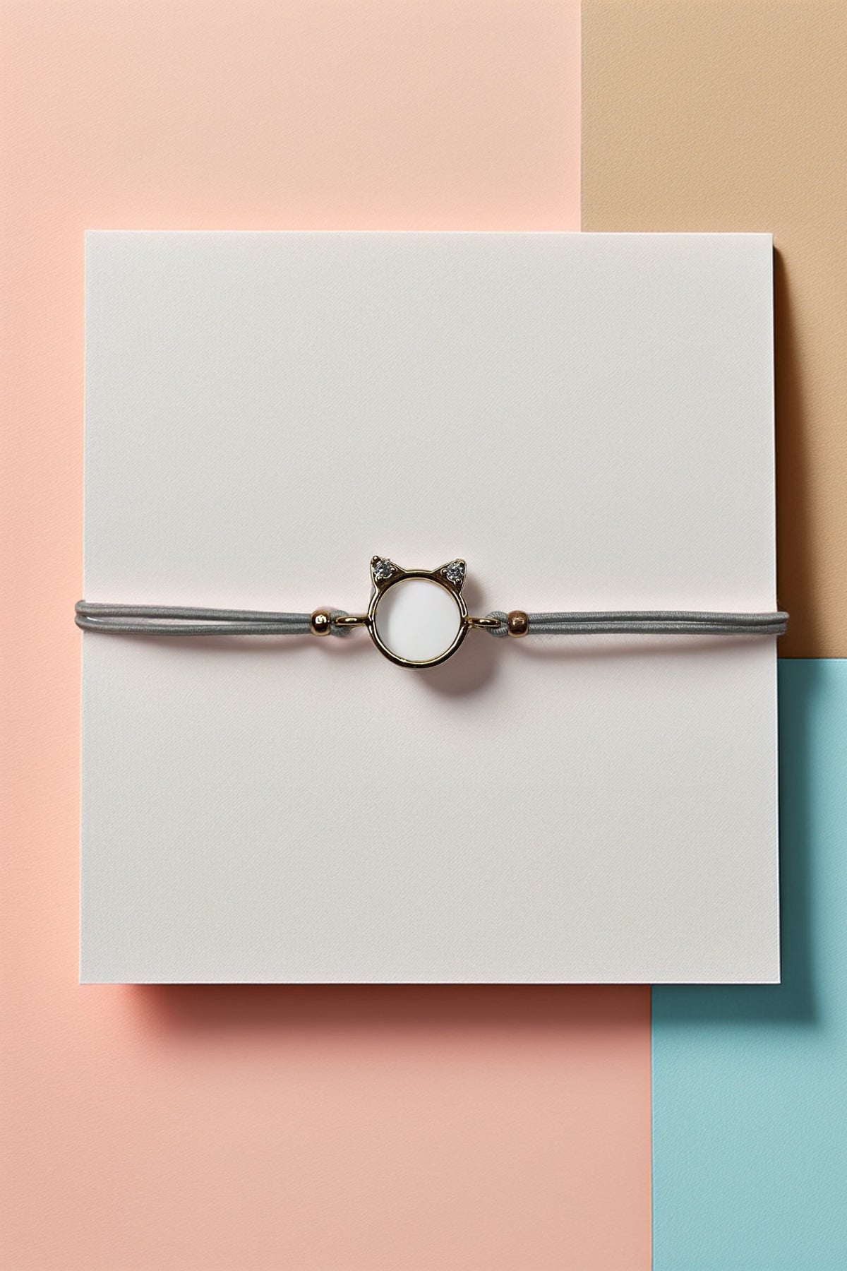 Cat charm bracelet on multicolored background