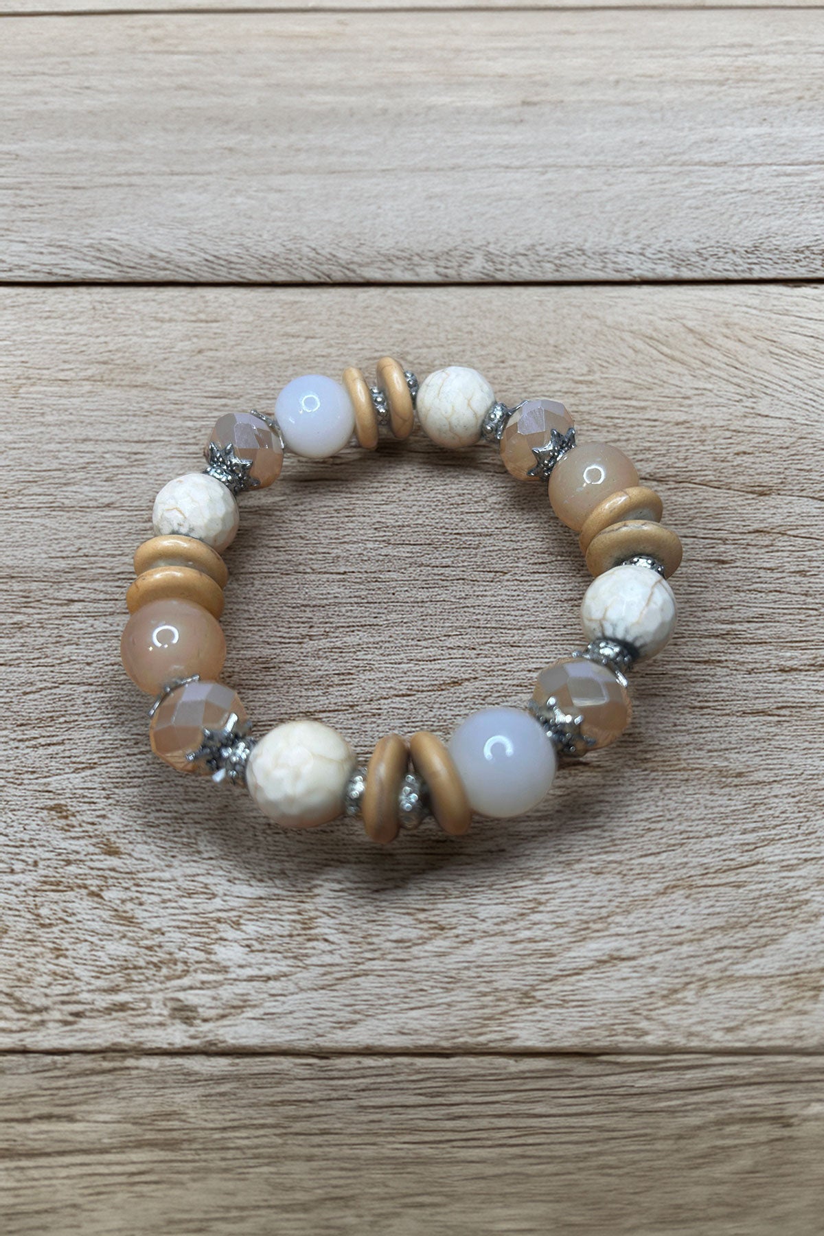 Elegant beaded bracelet on wooden surface