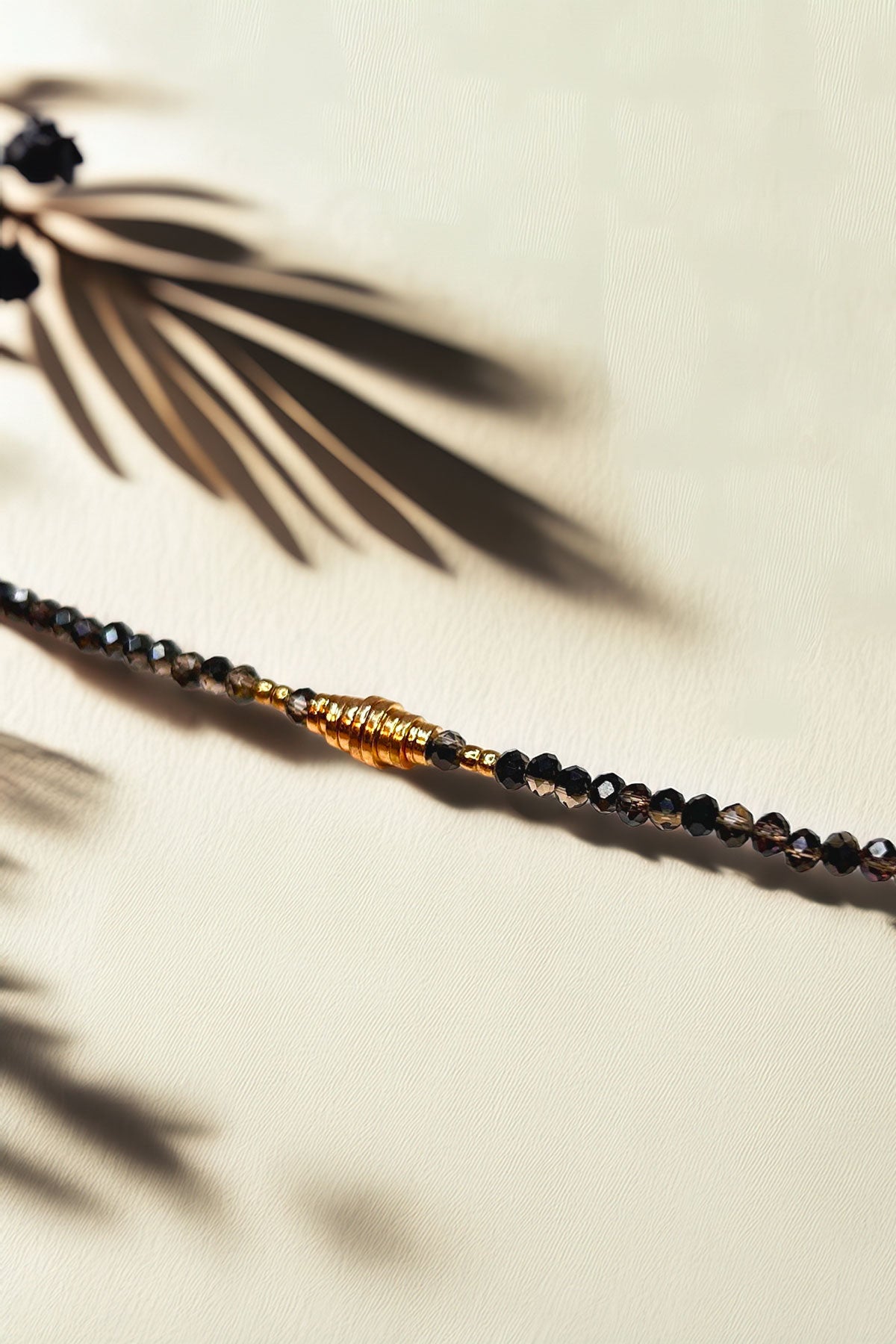 Close-up of the beaded bracelet highlighting gold accents and intricate bead design