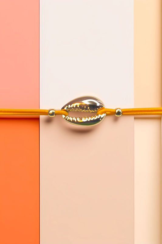 Close-up of cowrie shell bracelet on colorful background