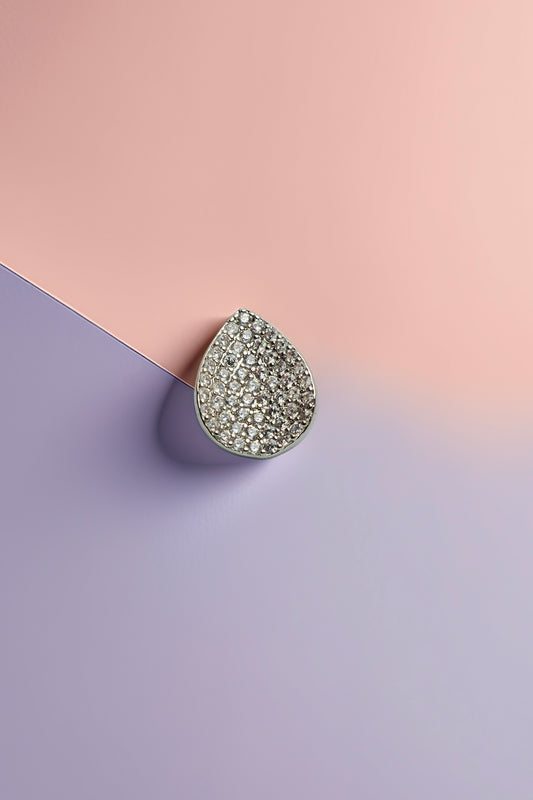 Teardrop stud earrings on pastel background