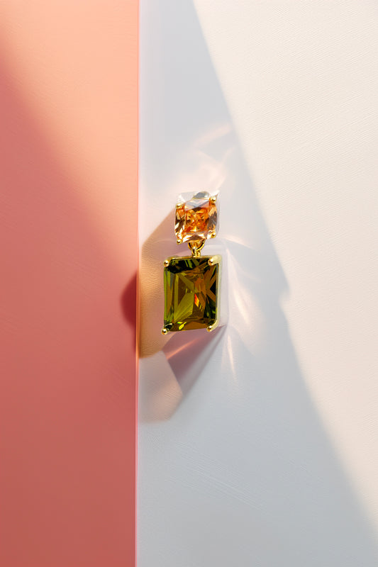 Front view of crystal drop earrings on textured background