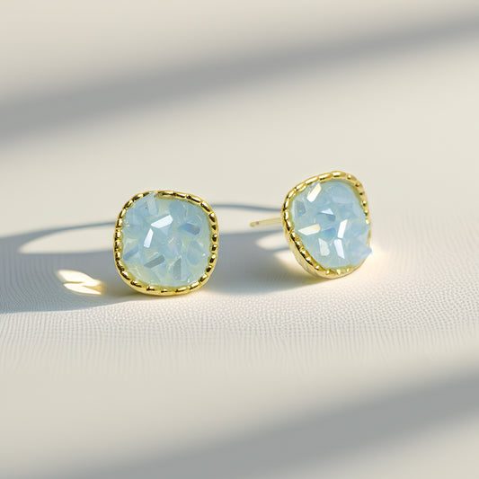 Front view of opal stud earrings with gold border