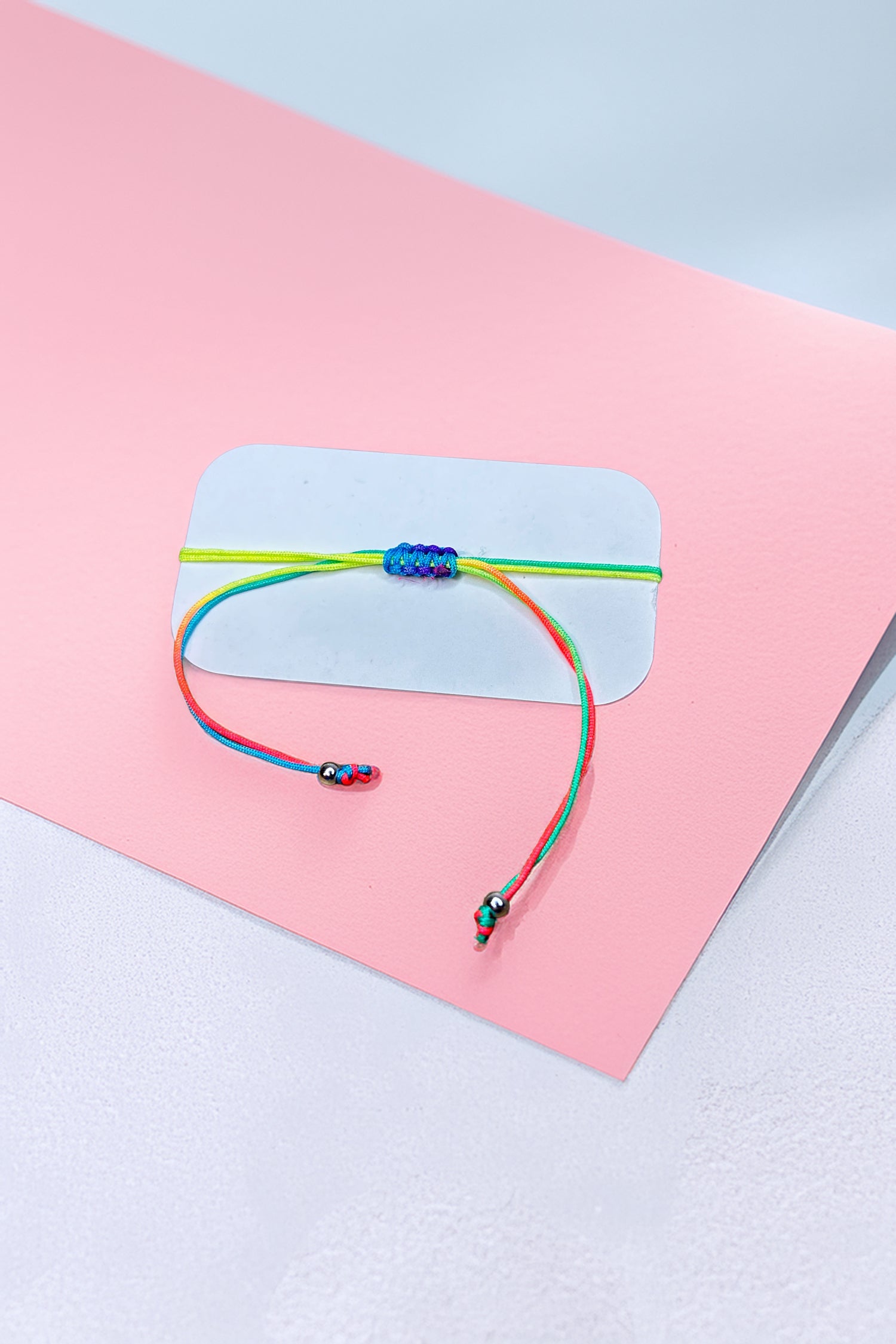 Rear view of the rainbow friendship bracelet with adjustable ties