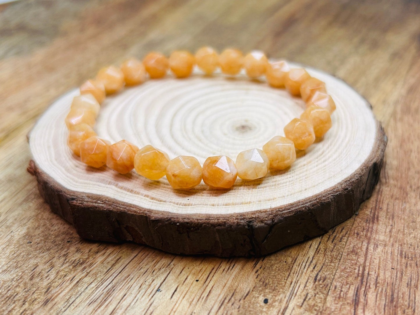 Orange beaded bracelet on wooden display