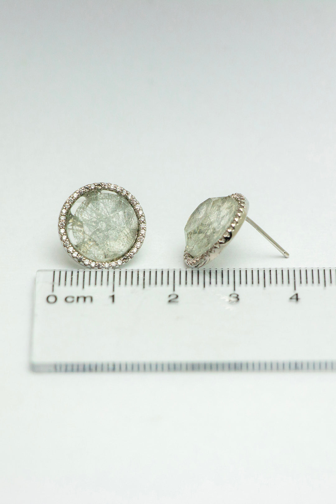Quartz stud earrings with ruler for size reference
