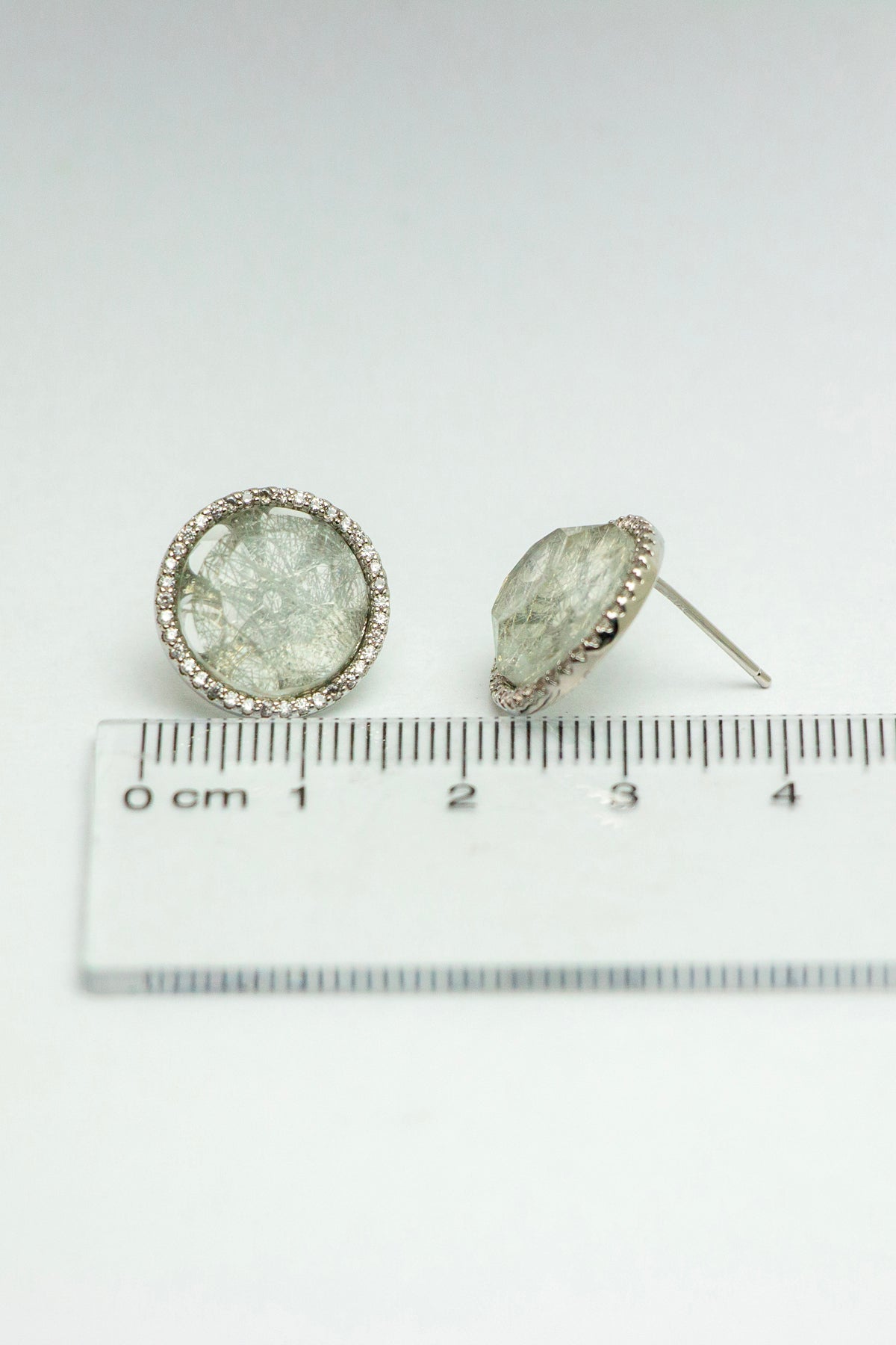 Quartz stud earrings with ruler for size reference