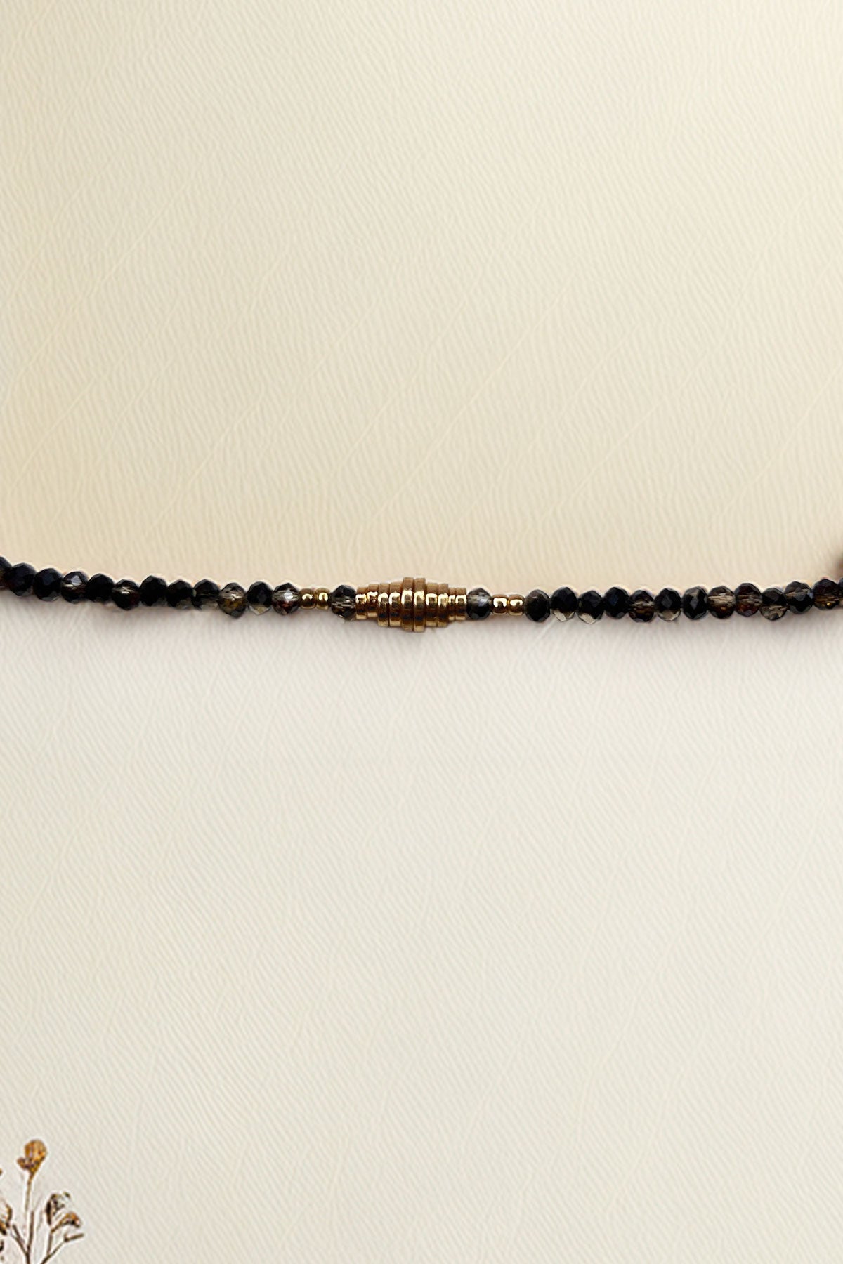 Full view of beaded bracelet with stylish gold centerpiece