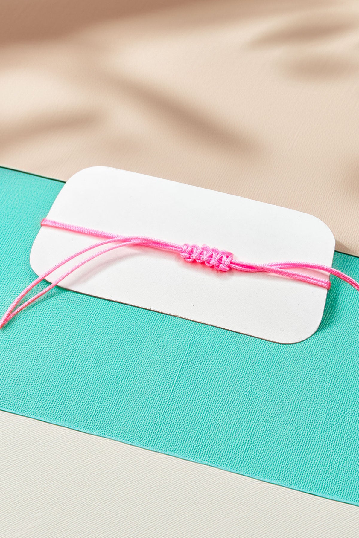 Back view of the adjustable pink cord bracelet