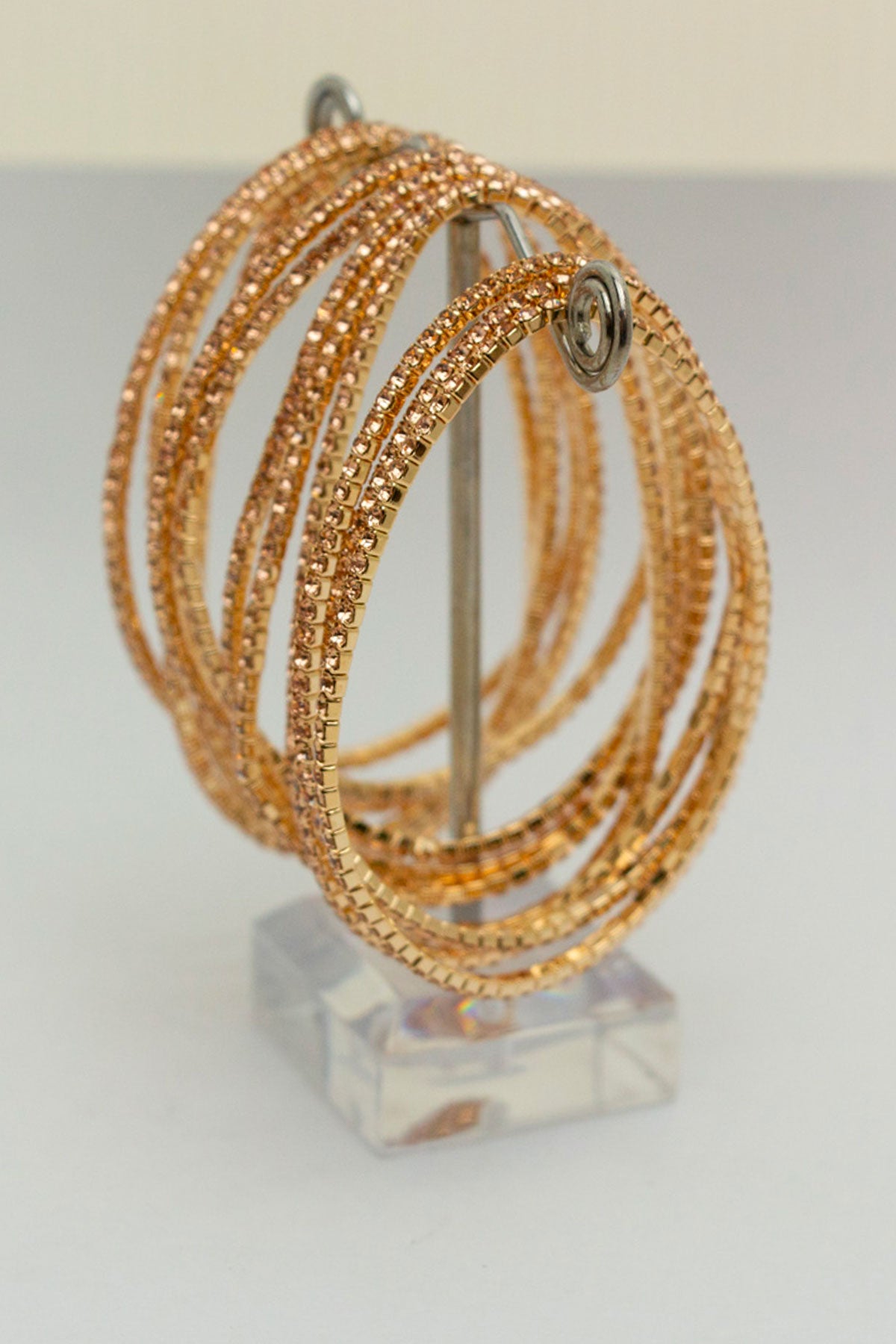 12 rhinestone bangles displayed on a metal stand