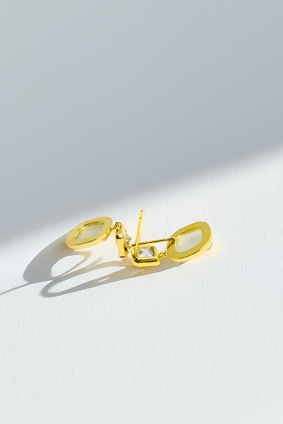 Side view of gold-tone dangle earrings
