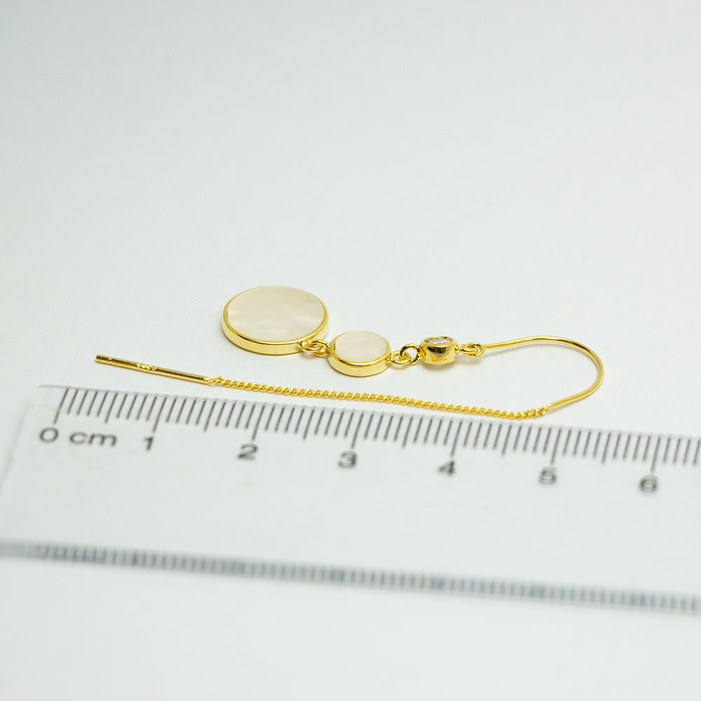 Gold drop earrings with ruler for size reference